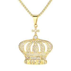 Macro detail of gold crown pendant featuring crystal inlay and KING lettering design