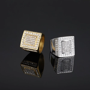 Hip hop style gold and silver square rings with full crystal pavé on black background