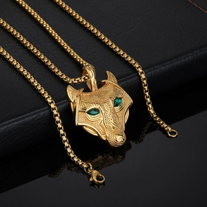 Gold Viking wolf head pendant necklace with green eyes and geometric engravings