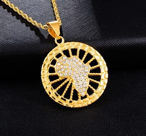 Detailed close-up of a hip-hop gold plated Africa map pendant with shiny zircons