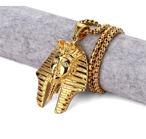 Detailed macro of golden Egyptian Pharaoh pendant with sparkling inlaid rhinestone eyes