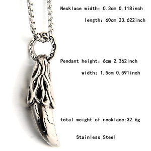 Detail of vintage wolf tooth pendant in stainless steel with carved texture and dimensions