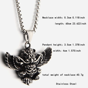 Macro detail of vintage angel pendant and 0.3cm stainless steel box chain necklace