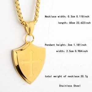Detailed view of golden shield cross pendant with chain measurements and dimensions