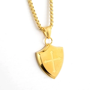 Vintage gold shield pendant necklace with a cross arrow pattern and square link chain