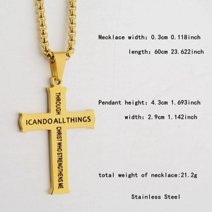 Detailed macro of golden stainless steel cross pendant with religious engraving