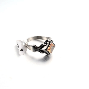 Detail of punk style stainless steel ring with orange gemstone and size 10 tag