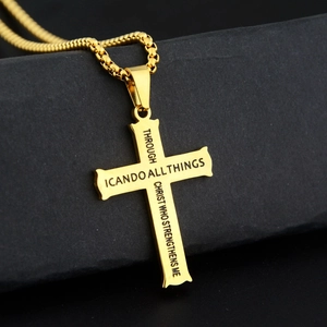 Golden titanium steel cross pendant necklace with Bible verse on black textured background