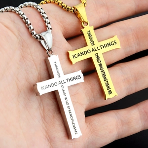 Close-up of gold and silver cross necklaces with engraved bible verse and pearl chain