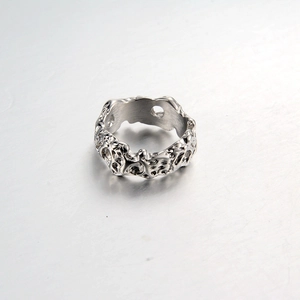 Detailed close-up of hip hop punk steel ring with irregular lava meteorite texture