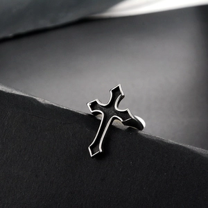 Macro shot of punk gothic stainless steel cross ring with black enamel inlay detail