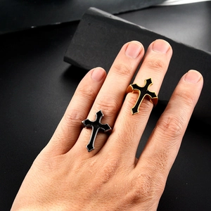 Close-up of gothic stainless steel cross rings in gold and silver finish for men