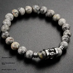 Detail of 8mm marble stone beads and skull charm on retro stainless steel bracelet