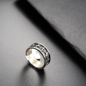 Macro view of vintage shield and stallion relief engraving on silver steel ring