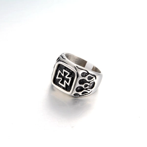 Detail of square signet ring with cross symbol and flame patterns in vintage steel