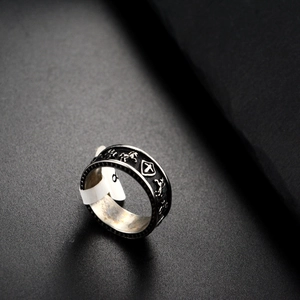 Close-up of hip hop punk style steel ring with horse and shield relief carvings