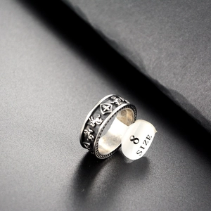 Macro shot of vintage titanium steel shield ring featuring horse and cross reliefs