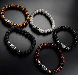 Five assorted natural stone beaded bracelets with vintage engraved steel cylinders