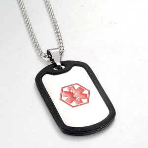 Detail view of medical alert dog tag with red Star of Life symbol and silicone silencer