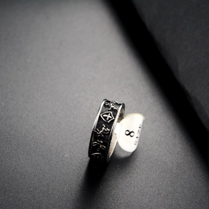 Macro detail of punk shield ring with horse relief and size 8 tag on dark surface