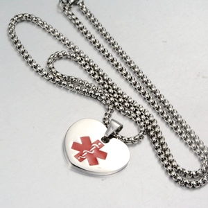 Detailed close-up of heart medical alert pendant with red Star of Life and box chain