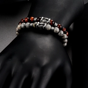 Detail of red tiger eye and map stone beaded bracelets on black hand display