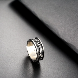 Macro shot of vintage titanium steel ring featuring horse relief and shield cross detail