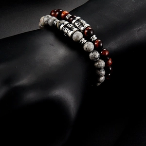 Detailed close-up of retro handmade beaded bracelet set with tiger eye and marble beads