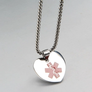 Detailed macro view of heart shaped medical ID necklace with pink star of life symbol