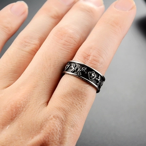 Macro detail of retro stainless steel shield and horse relief on a punk biker ring