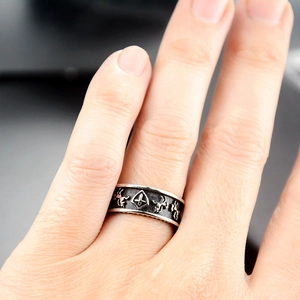 Macro shot of punk shield ring with vintage horse carving and oxidized steel finish