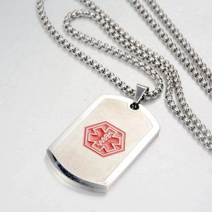 Detail of medical alert ID tag in brushed stainless steel with red Star of Life symbol