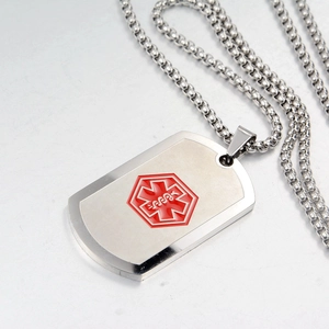 Macro shot of stainless steel medical alert dog tag with red Star of Life emblem