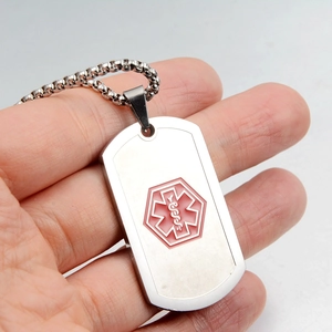 Close-up of brushed stainless steel medical alert dog tag necklace with red caduceus logo