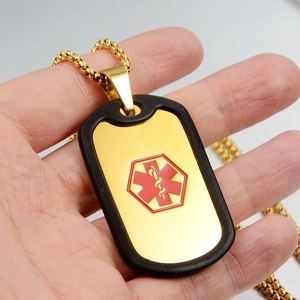 Detail shot of golden medical emergency alert tag with red star of life symbol and chain