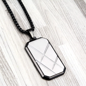 Men's rectangular dog tag necklace with geometric engraving and black bead chain