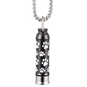 Close-up of black matte stainless steel pet cremation urn necklace with white paw prints