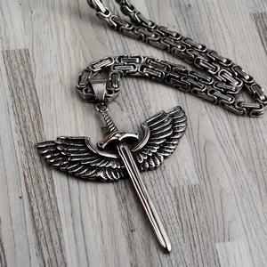 Gothic silver wing sword pendant necklace with Byzantine chain on wood surface