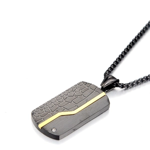 Detail of gunmetal military tag necklace with crocodile texture and gold inlay