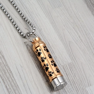 Dog paw print pet cremation urn necklace in silver and gold stainless steel