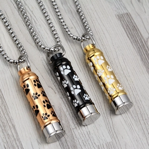 Three-color pet urn necklaces with paw prints in rose gold, black, and gold steel finish