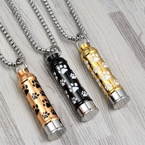 Cylinder cremation jewelry set with paw prints in rose gold black and silver colors
