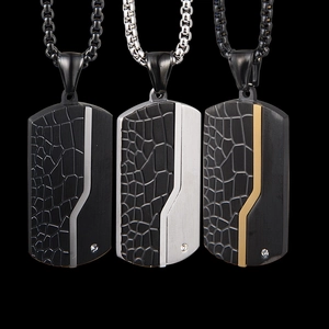 Detail of military tag necklaces with leather texture, brushed metal and crystal inlay