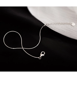 Close-up of S925 sterling silver snake chain with lobster clasp and adjustable extension link