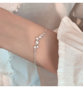 Close-up of elegant silver ginkgo leaf bracelet with matte texture on wrist