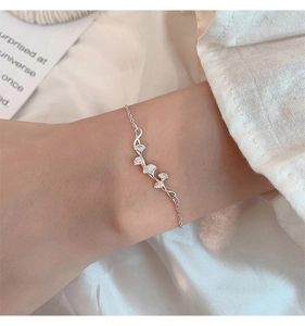 Detail shot of a s925 silver ginkgo leaf bracelet featuring textured veins on a woman's wrist