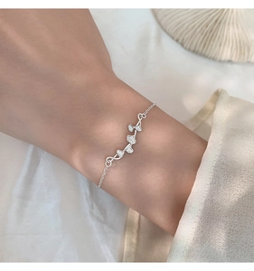 Detail of s925 silver ginkgo leaf bracelet showing delicate texture on female wrist