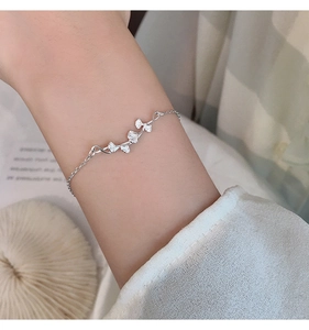 Detail of s925 silver ginkgo leaf bracelet showing three delicate layered leaves on a wrist