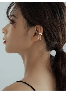 Detailed view of silver chain ear cuff on model ear showcasing minimalist design