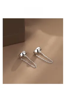 Detail of silver sterling ear cuff featuring a fine chain tassel and no-piercing design